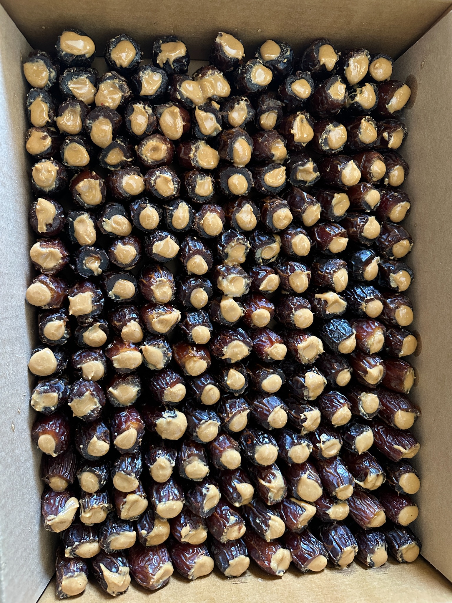 Whole DATELY® Medjool dates filled through the top with peanut butter
