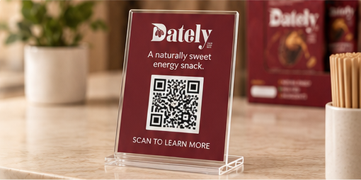 DATELY® sampling display with QR code on a café counter